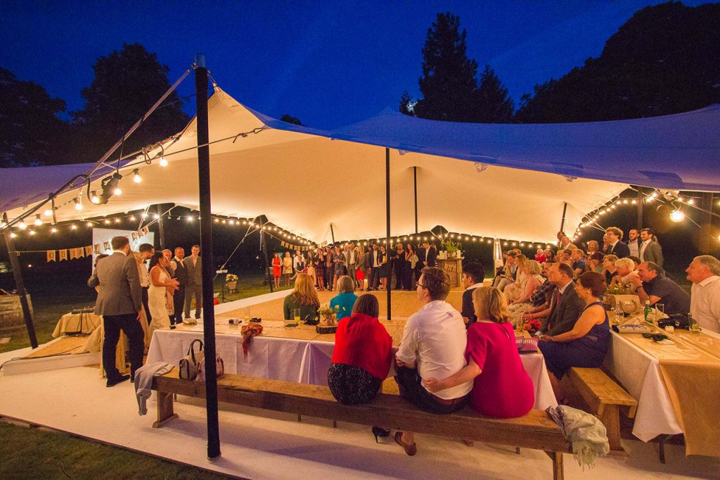 Wedding speeches under a white stretch tent in Essex