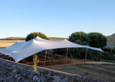 white stretch tent in meadow