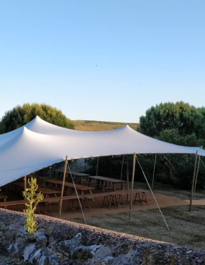 white stretch tent in meadow